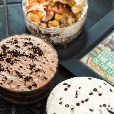 Three dessert bowls sit on a dark table.