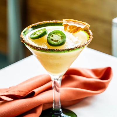 Frozen Margarita cocktail garnished with jalapeno slices.