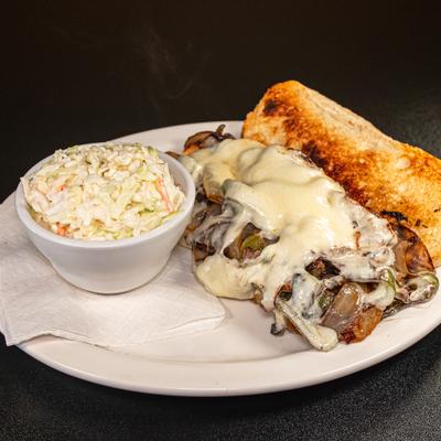 Steak philly sandwich with a side of coleslaw.