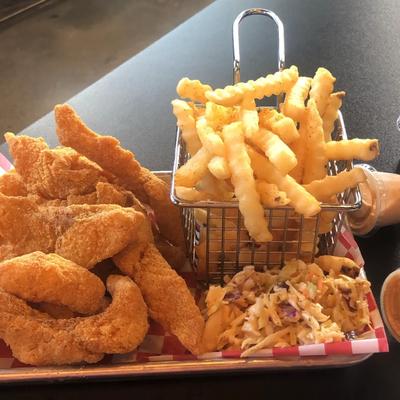 Fried fish , served with coleslaw and crinkle cut fries