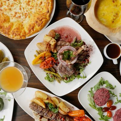 Various dishes served on the table alongside drinks, overhead view.