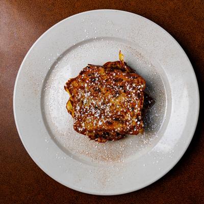 French toast topped with powdered sugar on a plate.