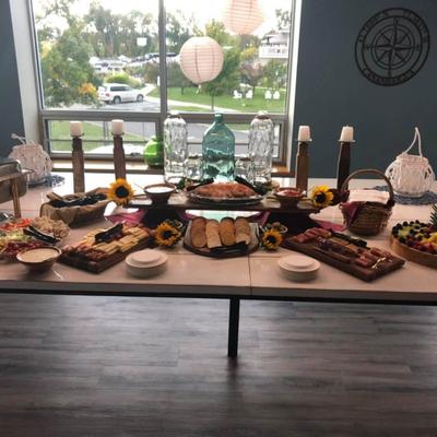 Large grazing table with  selection of cured meats and cheeses, fruits, vegetables and condiments.