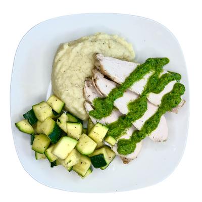 Chicken with sauteed zucchini, mashed cauliflower, and green sauce.