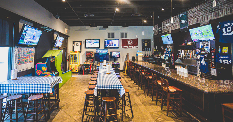 Interior, bar area on the right and a long tall table in the middle
