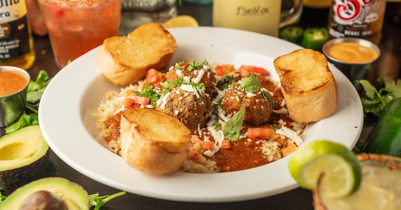 Meatballs with toasted bread, rice, and sauce