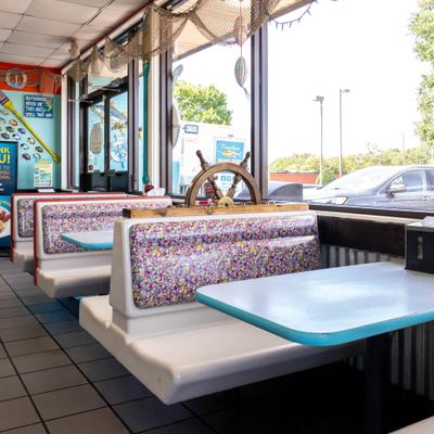 Vintage 1990s Taco Bell booths are creatively repurposed inside a nautical-themed seafood diner.
