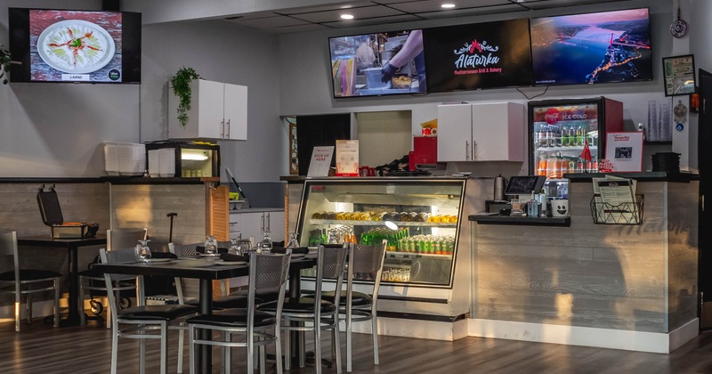 Interior, tables with chairs and an ordering counter in the back