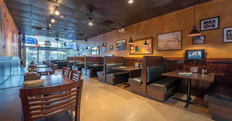 Interior, wide view, tables, chairs and black leather benches