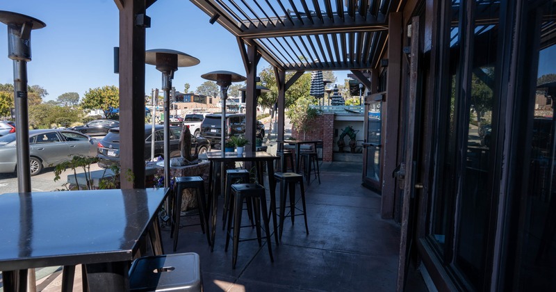 Exterior, restaurant front, high seating tables for four, space heaters