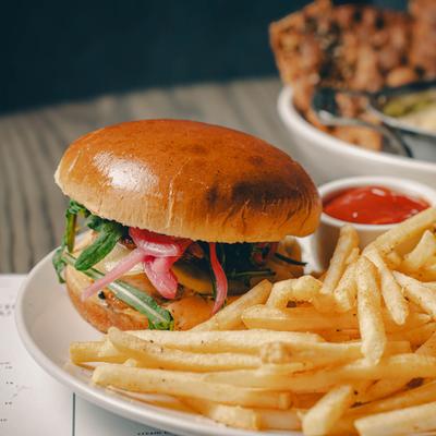 Grilled Chicken Sandwich with fries, close up.