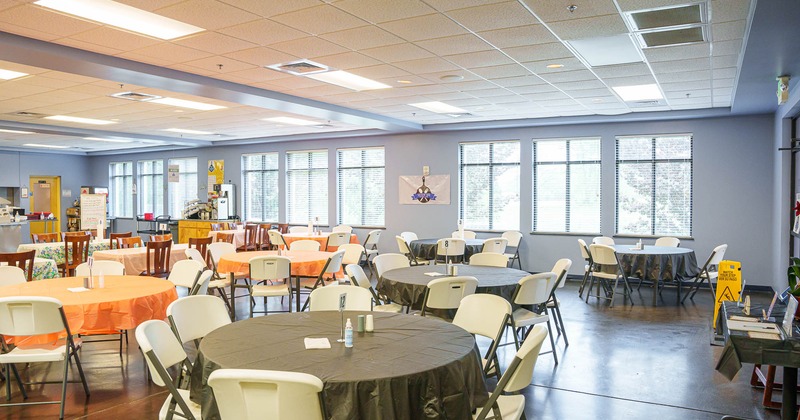 Interior, round tables and chairs with windows in the back