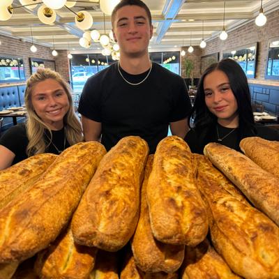 The staff posing with freshly baked pastry.