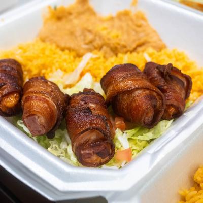 Bacon wraps served with lettuce, rice and beans.