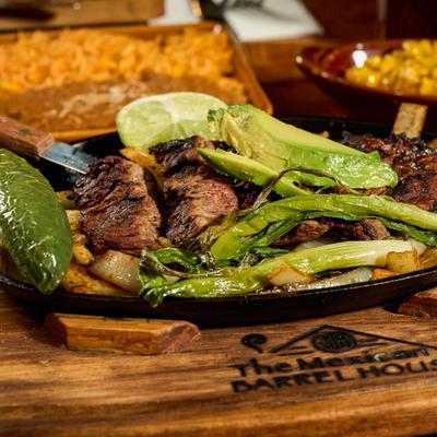 Steak fajita platter with grilled onions, jalapeno, green onion and avocado.