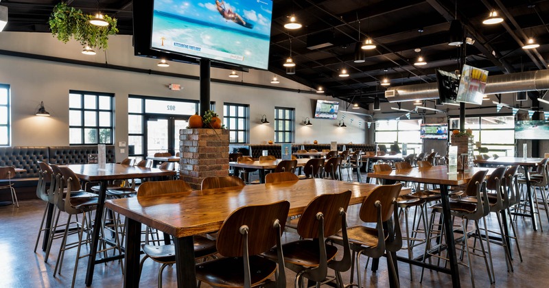 Interior, tv above tables and chairs in seating area