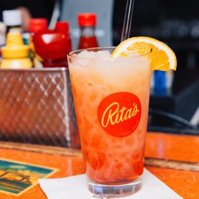 A colorful cocktail in a glass with 