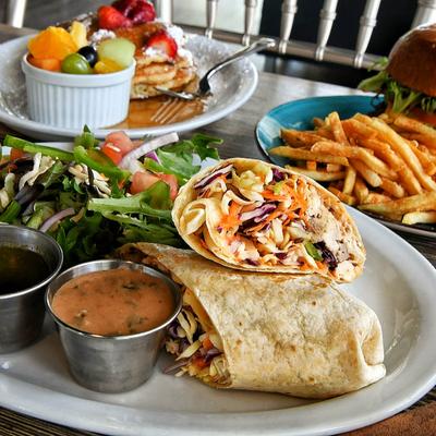 Thai Chicken Wrap with side salad, peanut dipping sauce and sriracha aioli.