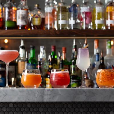 Assorted cocktails aligned on bar counter