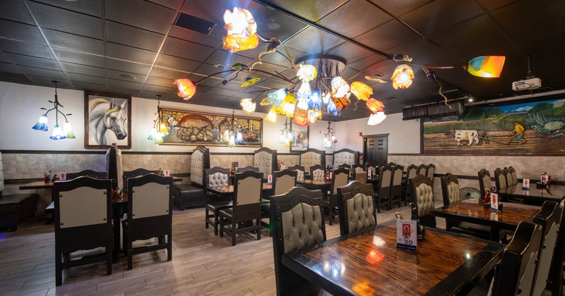 Interior, open space dining area, wooden tables and chairs, tile flooring