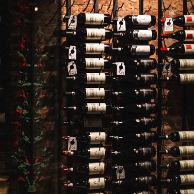 Large wall of horizontally stored wine bottles.