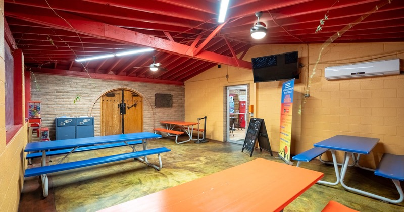 Interior, picnic tables, TV on the wall