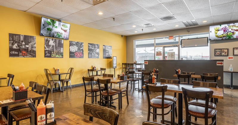 Interior, dining area, tables and chairs ready for guests, restaurant entrance