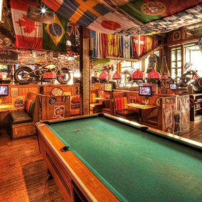 A lively interior with a pool table in the foreground