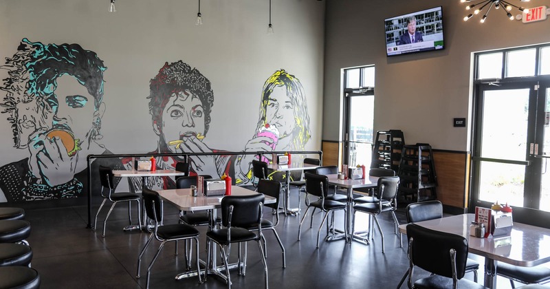 Interior, dining tables, mural art on a wall