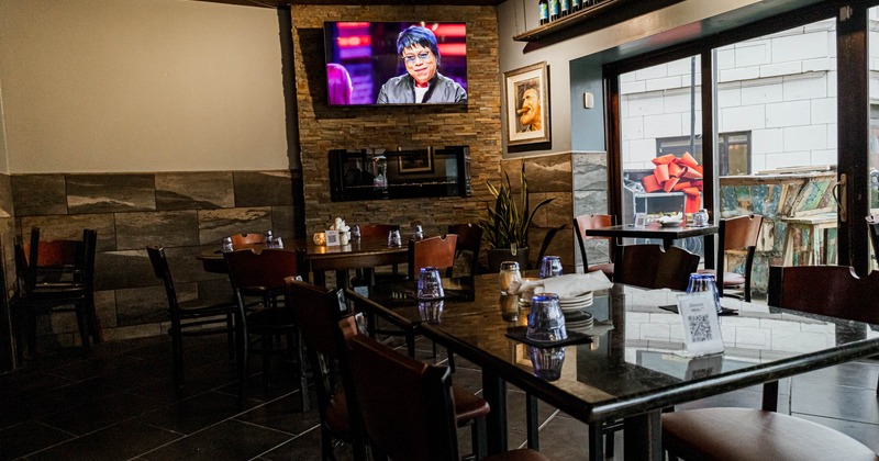 Dining area, the TV screen on the wall above.