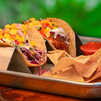 Tacos, served with tortilla chips, and salsa.