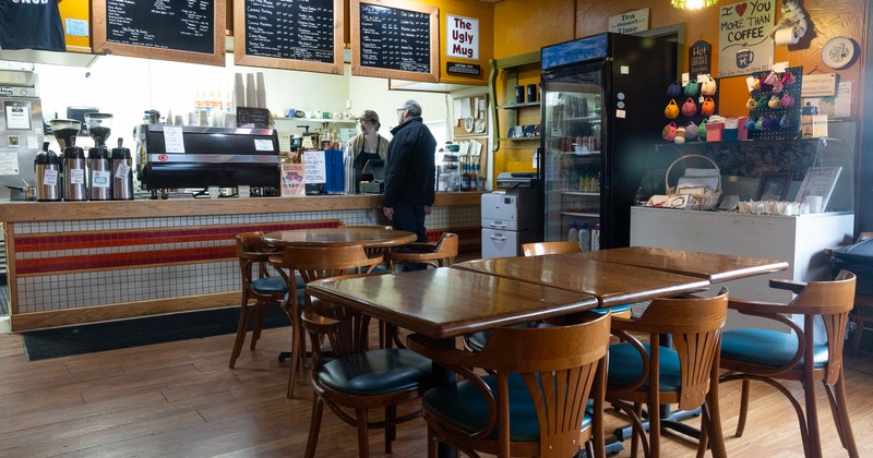Interior, diner area, tables, chairs, food counter behind