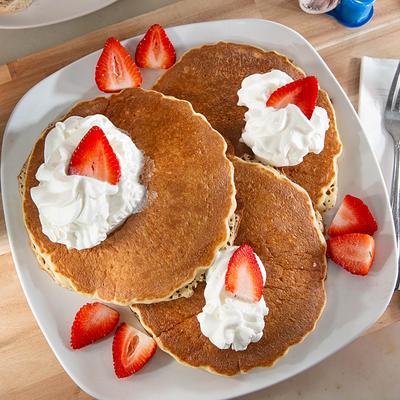 Buttermilk Pancakes with strawberries and whipped cream.