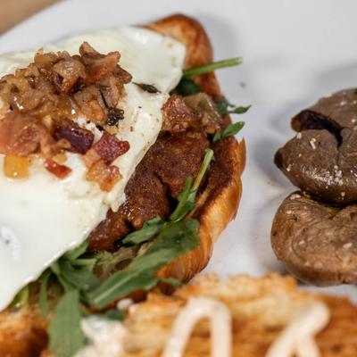 Breakfast sandwich with egg and potatoes.