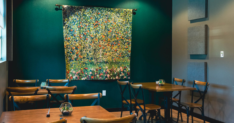 Interior, sieating area with a large colorful painting hanging on the wall