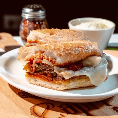 Breaded Steak Sandwich with melted mozzarella, hot peppers, and marinara sauce.