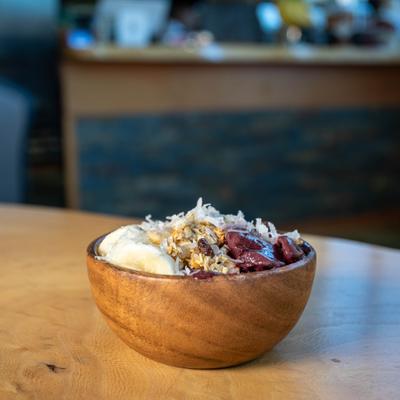 Acai bowl with berries, banana, granola, and coconut flakes.