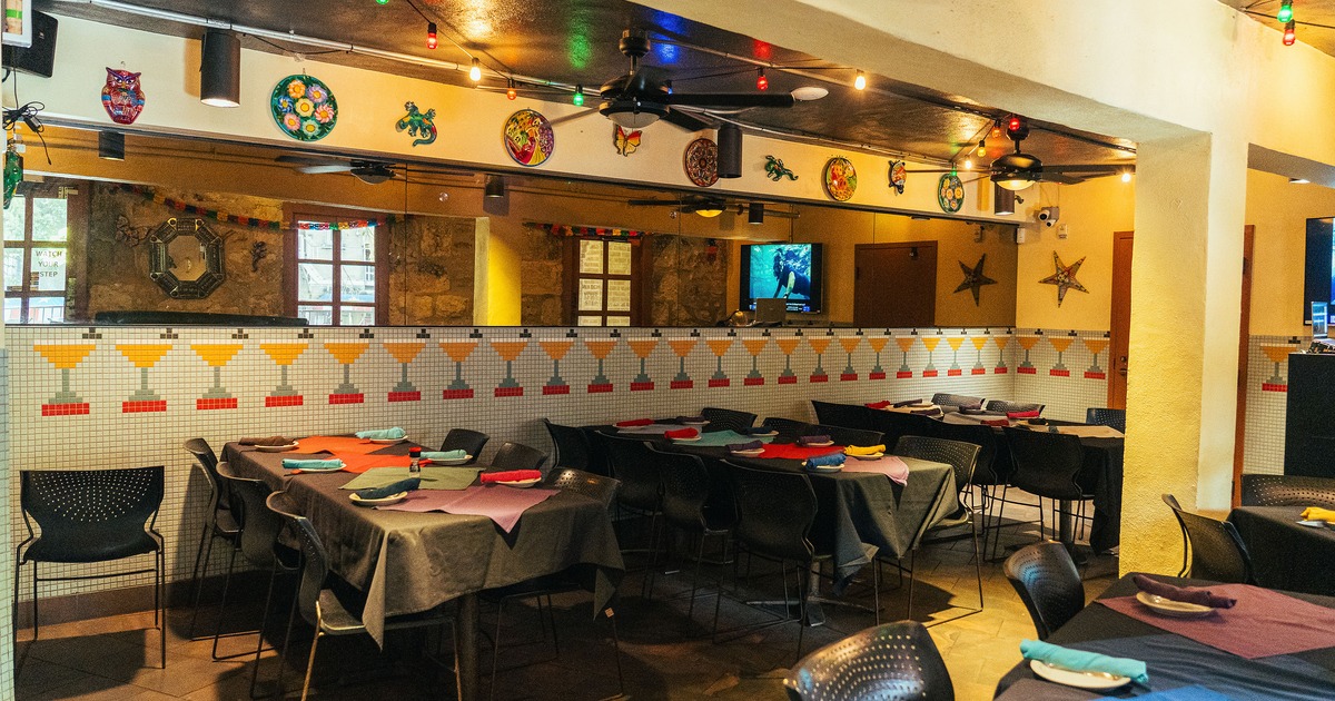 Interior of cozy dining area with dining tables set for guests