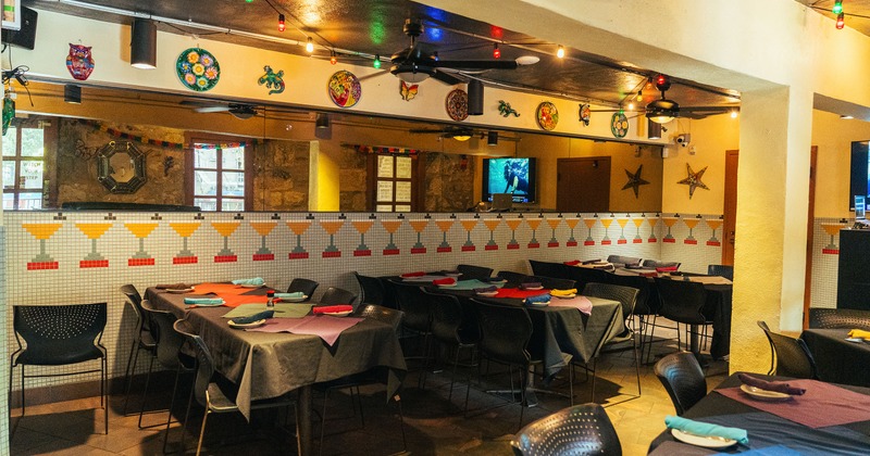 Interior of cozy dining area with dining tables set for guests
