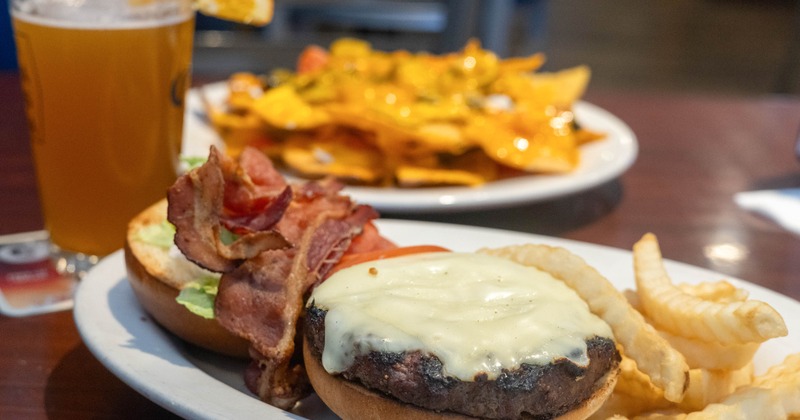 Bacon cheeseburger with lettuce, tomato, mayo, and fries