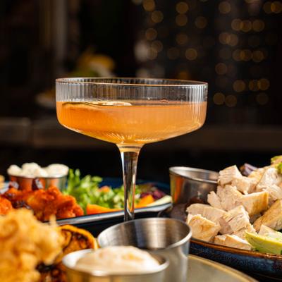 Breakfast Martini surrounded by plates of food.