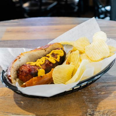Hot dog with chips, served on the table.
