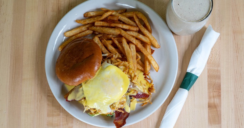 Bacon cheeseburger, with crispy shredded potatoes, egg, Hollandaise sauce, and fries