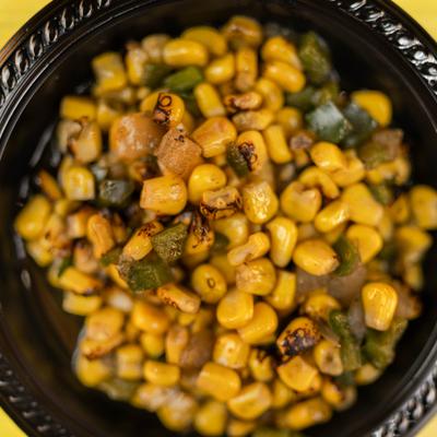 Roasted Corn mixed with diced peppers and onions, close-up.