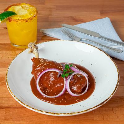Chicken leg smothered in Mole sauce.