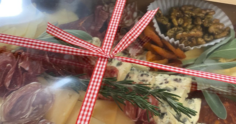 Gift wrapped charcuterie box with ribbon