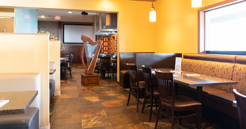 Interior, booths and banquette seating , a harp in the middle of the room