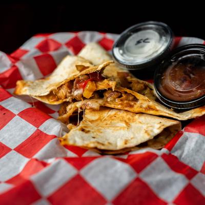 Served quesadilla with dips.