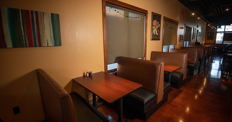 Interior dining area with lined up upholstered dining booths