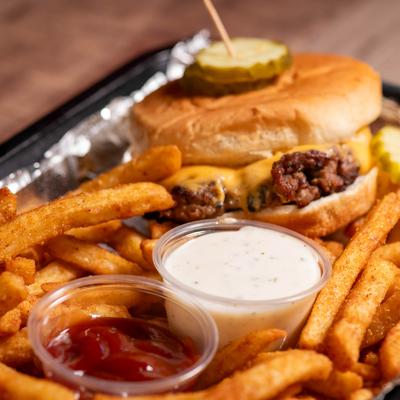 Cheddar Burger served with fries and two dips.